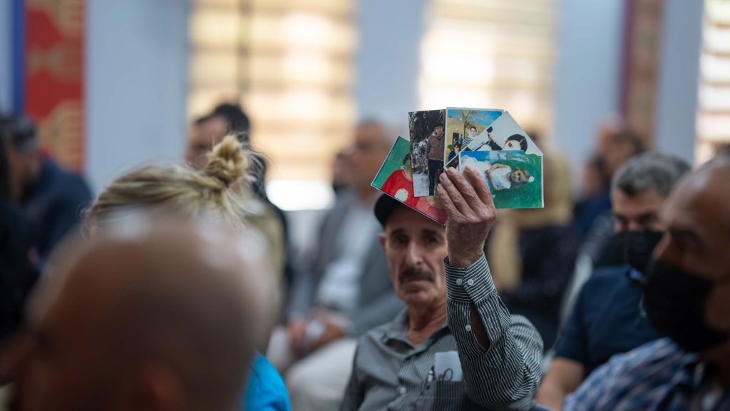 Abo Majed holds photos of missing family members